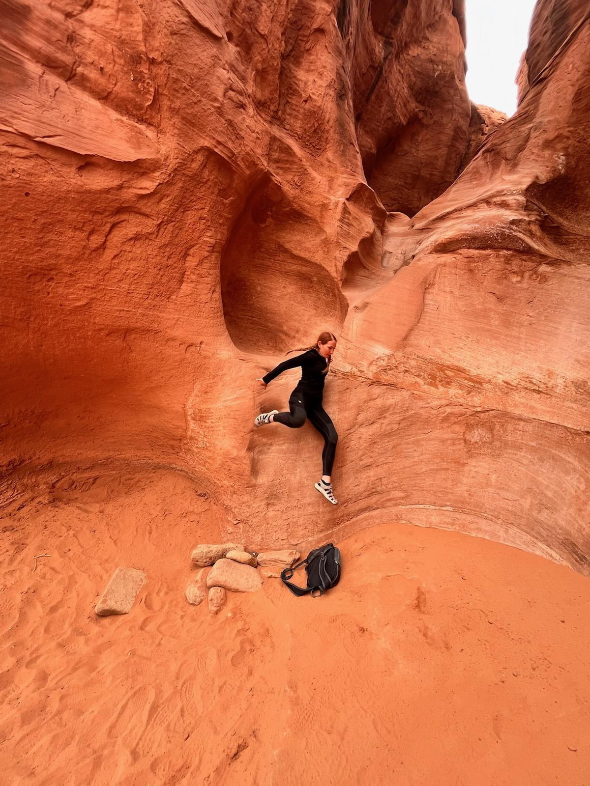 Jodi Riley moving through a sandstone canyon
